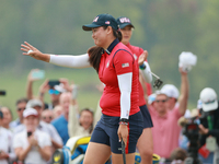 GAINESVILLE, VIRGINIA - SEPTEMBER 13: Allisen Corpuz of the United States acknowledges the gallery at the 16th green during Foursome Matches...