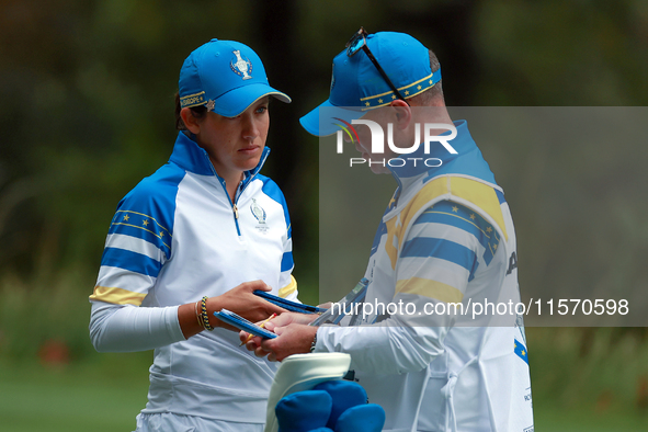 GAINESVILLE, VIRGINIA - SEPTEMBER 13: Albane Valenzuela of Team Europe talks with her caddie on the 9th green during Day One of the Solheim...