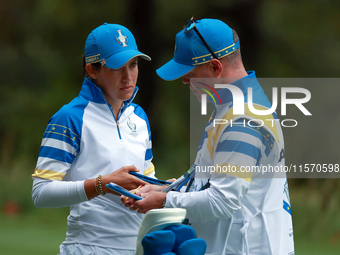 GAINESVILLE, VIRGINIA - SEPTEMBER 13: Albane Valenzuela of Team Europe talks with her caddie on the 9th green during Day One of the Solheim...