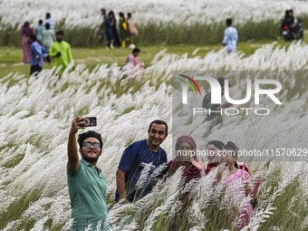 People visit the kans grass flower field in the afternoon in the Saraighat area in Dhaka, Bangladesh, on September 13, 2024. (