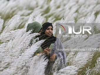 People visit the kans grass flower field in the afternoon in the Saraighat area in Dhaka, Bangladesh, on September 13, 2024. (