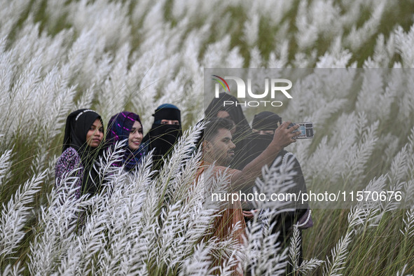 People visit the kans grass flower field in the afternoon in the Saraighat area in Dhaka, Bangladesh, on September 13, 2024. 