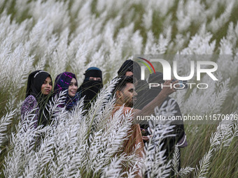 People visit the kans grass flower field in the afternoon in the Saraighat area in Dhaka, Bangladesh, on September 13, 2024. (