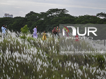 People visit the kans grass flower field in the afternoon in the Saraighat area in Dhaka, Bangladesh, on September 13, 2024. (