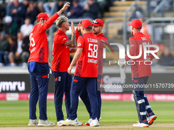 #92, Brydon Carse of England (2nd left) celebrates taking the wicket of #62, Travis Head of Australia during the Second Vitality T20 Interna...