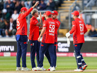 #92, Brydon Carse of England (2nd left) celebrates taking the wicket of #62, Travis Head of Australia during the Second Vitality T20 Interna...