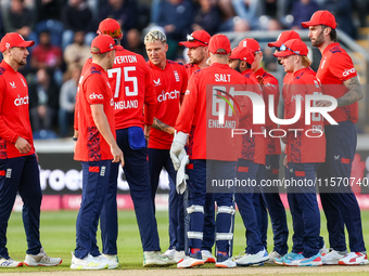 #92, Brydon Carse of England (center - facing camera) celebrates the opening wicket with teammates during the Second Vitality T20 Internatio...