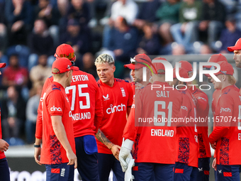 #92, Brydon Carse of England (center - facing camera) celebrates the opening wicket with teammates during the Second Vitality T20 Internatio...