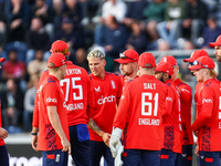 #92, Brydon Carse of England (center - facing camera) celebrates the opening wicket with teammates during the Second Vitality T20 Internatio...