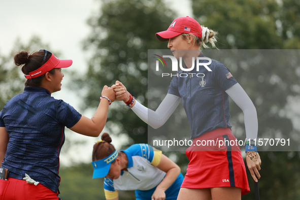 GAINESVILLE, VIRGINIA - SEPTEMBER 13: Nelly Korda of the United States (R) celebrates with her teammate Megan Khang (L) after her putt on th...