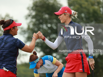 GAINESVILLE, VIRGINIA - SEPTEMBER 13: Nelly Korda of the United States (R) celebrates with her teammate Megan Khang (L) after her putt on th...