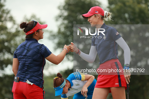 GAINESVILLE, VIRGINIA - SEPTEMBER 13: Nelly Korda of the United States (R) celebrates with her teammate Megan Khang (L) after her putt on th...