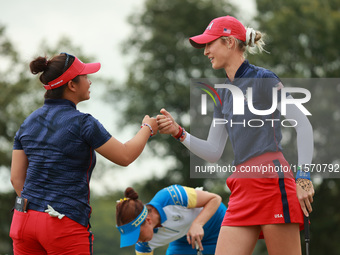 GAINESVILLE, VIRGINIA - SEPTEMBER 13: Nelly Korda of the United States (R) celebrates with her teammate Megan Khang (L) after her putt on th...