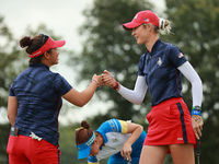 GAINESVILLE, VIRGINIA - SEPTEMBER 13: Nelly Korda of the United States (R) celebrates with her teammate Megan Khang (L) after her putt on th...