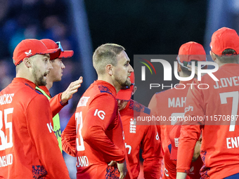 #23, Liam Livingstone of England (center facing right), celebrates taking the wicket of #17, Marcus Stones of Australia, caught by #75, Jami...