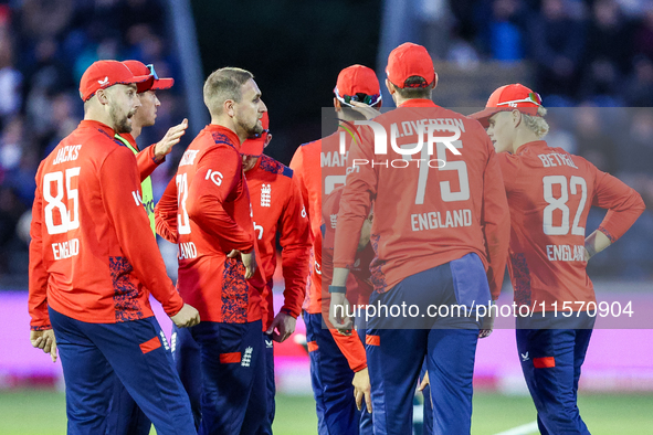 #23, Liam Livingstone of England (center facing right), celebrates taking the wicket of #17, Marcus Stones of Australia, caught by #75, Jami...