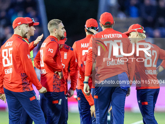 #23, Liam Livingstone of England (center facing right), celebrates taking the wicket of #17, Marcus Stones of Australia, caught by #75, Jami...