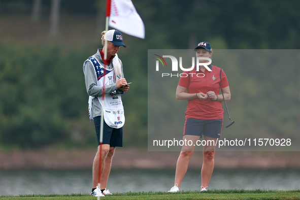 GAINESVILLE, VIRGINIA - SEPTEMBER 13: Ally Ewing of the United States waits on the 9th green with her caddie during Day One of the Solheim C...