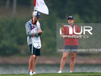 GAINESVILLE, VIRGINIA - SEPTEMBER 13: Ally Ewing of the United States waits on the 9th green with her caddie during Day One of the Solheim C...