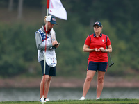 GAINESVILLE, VIRGINIA - SEPTEMBER 13: Ally Ewing of the United States waits on the 9th green with her caddie during Day One of the Solheim C...