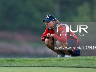 GAINESVILLE, VIRGINIA - SEPTEMBER 13: Jennifer Kupcho of the United States lines up her putt on the 9th green during Day One of the Solheim...