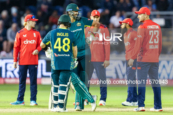 Josh Inglis of Australia and Tim David stand at the crease as they await the outcome of an unsuccessful DRS review against the latter during...