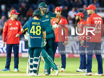 Josh Inglis of Australia and Tim David stand at the crease as they await the outcome of an unsuccessful DRS review against the latter during...