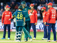 Josh Inglis of Australia and Tim David stand at the crease as they await the outcome of an unsuccessful DRS review against the latter during...