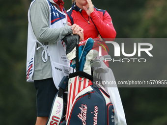 GAINESVILLE, VIRGINIA - SEPTEMBER 13: Jennifer Kupcho of the United States interact with her caddie on the 8th green during Foursome Matches...