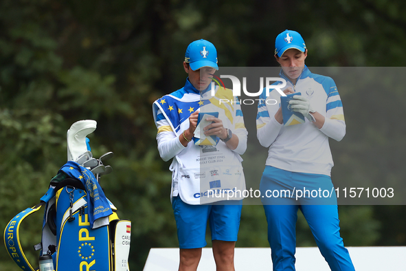 GAINESVILLE, VIRGINIA - SEPTEMBER 13: Carlota Ciganda of Team Europe makes notes with her caddie at the 9th tee during Day One of the Solhei...