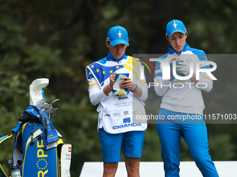 GAINESVILLE, VIRGINIA - SEPTEMBER 13: Carlota Ciganda of Team Europe makes notes with her caddie at the 9th tee during Day One of the Solhei...