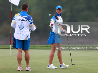 GAINESVILLE, VIRGINIA - SEPTEMBER 13: Linn Grant of of Team Europe tosses her ball to her caddie during Day One of the Solheim Cup at Robert...