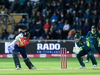 Jacob Bethell of England edges the ball to the boundary for 4 as Josh Inglis of Australia watches during the Second Vitality T20 Internation...