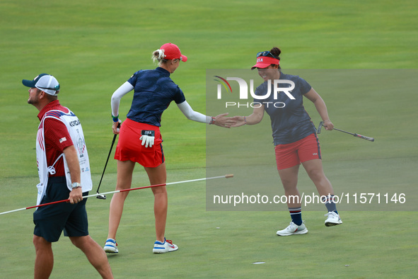 GAINESVILLE, VIRGINIA - SEPTEMBER 13: Nelly Korda of the United States (L) celebrates with her teammate Megan Khang (R) after her putt on th...