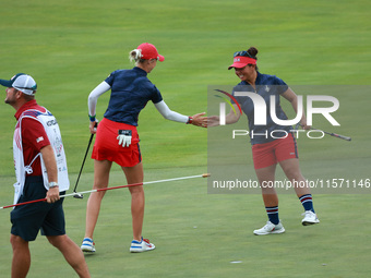 GAINESVILLE, VIRGINIA - SEPTEMBER 13: Nelly Korda of the United States (L) celebrates with her teammate Megan Khang (R) after her putt on th...