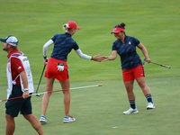 GAINESVILLE, VIRGINIA - SEPTEMBER 13: Nelly Korda of the United States (L) celebrates with her teammate Megan Khang (R) after her putt on th...