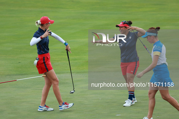 GAINESVILLE, VIRGINIA - SEPTEMBER 13: Nelly Korda of the United States (L) celebrates with her teammate Megan Khang (R) after her putt on th...