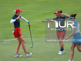 GAINESVILLE, VIRGINIA - SEPTEMBER 13: Nelly Korda of the United States (L) celebrates with her teammate Megan Khang (R) after her putt on th...