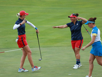 GAINESVILLE, VIRGINIA - SEPTEMBER 13: Nelly Korda of the United States (L) celebrates with her teammate Megan Khang (R) after her putt on th...