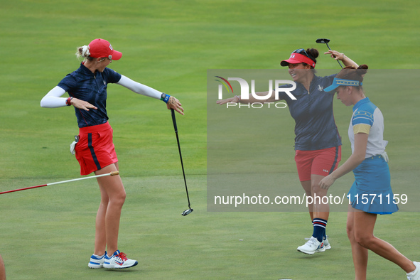 GAINESVILLE, VIRGINIA - SEPTEMBER 13: Nelly Korda of the United States (L) celebrates with her teammate Megan Khang (R) after her putt on th...