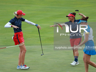 GAINESVILLE, VIRGINIA - SEPTEMBER 13: Nelly Korda of the United States (L) celebrates with her teammate Megan Khang (R) after her putt on th...