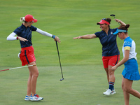 GAINESVILLE, VIRGINIA - SEPTEMBER 13: Nelly Korda of the United States (L) celebrates with her teammate Megan Khang (R) after her putt on th...