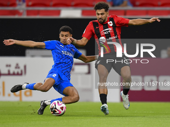 Hazem Ahmed Shehata (R) of Al Rayyan SC battles for the ball with Mohammed Ibrahim (L) of Al Shahania SC during the Ooredoo Qatar Stars Leag...