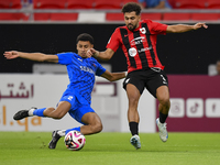 Hazem Ahmed Shehata (R) of Al Rayyan SC battles for the ball with Mohammed Ibrahim (L) of Al Shahania SC during the Ooredoo Qatar Stars Leag...