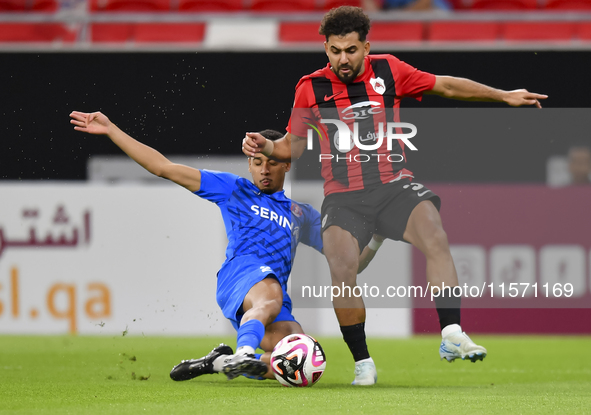 Hazem Ahmed Shehata (R) of Al Rayyan SC battles for the ball with Mohammed Ibrahim (L) of Al Shahania SC during the Ooredoo Qatar Stars Leag...