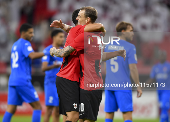 Mahmoud Ahmed Hassan (L) of Al Rayyan SC celebrates with his teammate after scoring a goal during the Ooredoo Qatar Stars League 24/25 match...