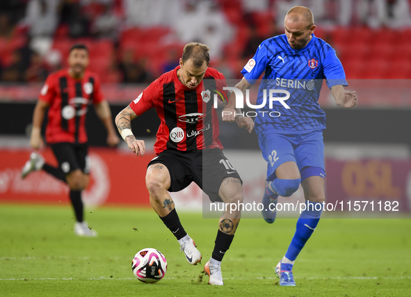 Roger Krug Guedes (L) of Al Rayyan SC battles for the ball with Andreas Van Beek (R) of Al Shahania SC during the Ooredoo Qatar Stars League...