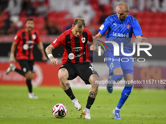 Roger Krug Guedes (L) of Al Rayyan SC battles for the ball with Andreas Van Beek (R) of Al Shahania SC during the Ooredoo Qatar Stars League...