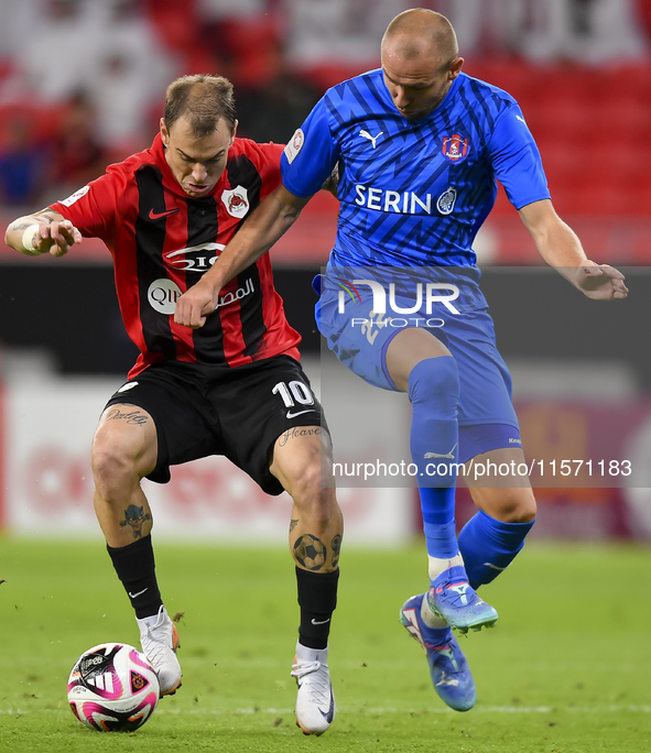 Roger Krug Guedes (L) of Al Rayyan SC battles for the ball with Andreas Van Beek (R) of Al Shahania SC during the Ooredoo Qatar Stars League...