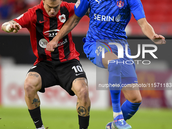 Roger Krug Guedes (L) of Al Rayyan SC battles for the ball with Andreas Van Beek (R) of Al Shahania SC during the Ooredoo Qatar Stars League...